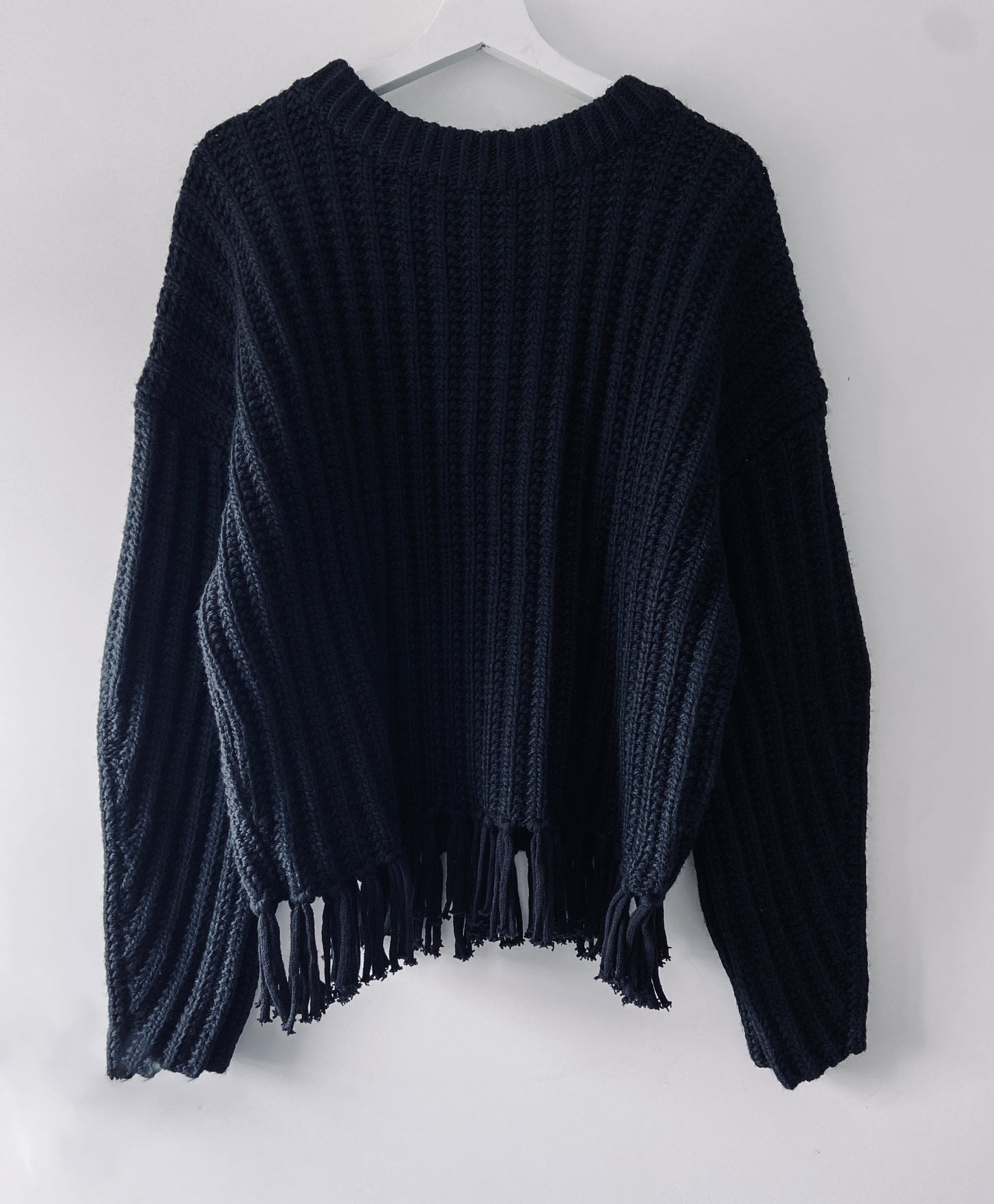 Black knitted ribbed sweater with fringes